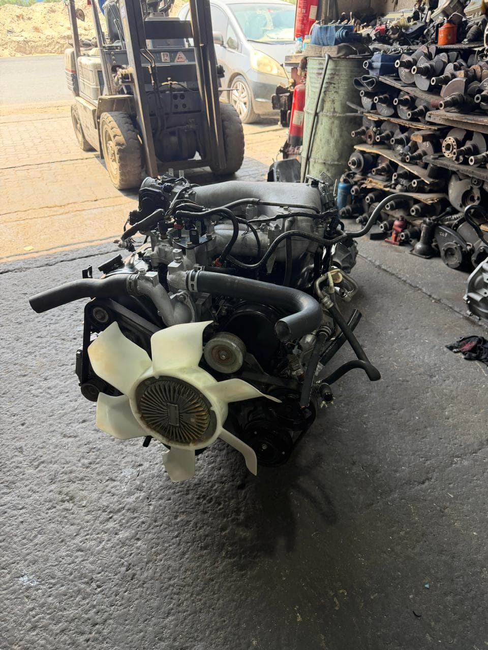 Used engine and cooling fan standing outside the shop